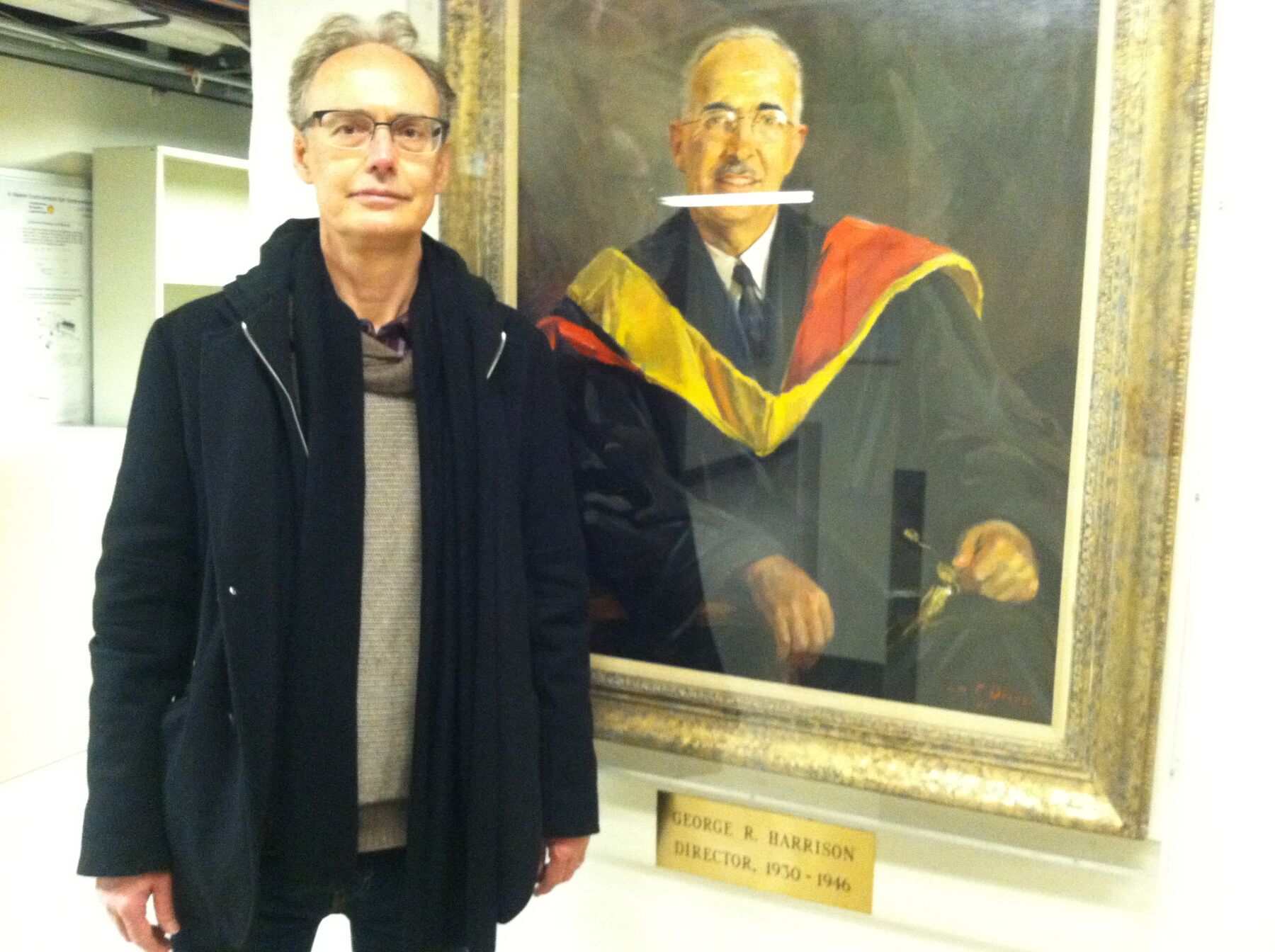 With portrait of his grandfather at MIT